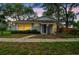 Charming single-story home with neutral exterior, mature trees, and inviting front entrance at 14732 Morning Dr, Lutz, FL 33559