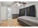 Main bedroom with an en-suite bathroom, dresser, a ceiling fan, and dark curtains at 14732 Morning Dr, Lutz, FL 33559