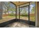 Enclosed patio with views of a wooden fenced backyard surrounded by trees at 14732 Morning Dr, Lutz, FL 33559