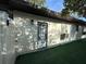 The backyard features synthetic grass, shadow covered walls, and a backdoor for easy access at 1515 E Hanna Ave, Tampa, FL 33610