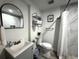Modern bathroom with a tiled shower, sleek vanity, and convenient towel storage at 1515 E Hanna Ave, Tampa, FL 33610
