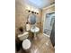 Classic bathroom featuring tiled floors, a pedestal sink, and a toilet at 1515 E Hanna Ave, Tampa, FL 33610