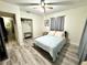 Comfortable bedroom featuring wood floors, closet, and ample natural light at 1515 E Hanna Ave, Tampa, FL 33610