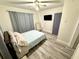 Cozy bedroom with hardwood floors, ceiling fan, and a minimalist design at 1515 E Hanna Ave, Tampa, FL 33610