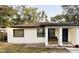 Charming single-story home with a cozy front porch and neutral-colored stucco exterior at 1515 E Hanna Ave, Tampa, FL 33610