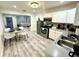 Well-lit kitchen with stainless steel appliances and an adjacent dining area with seating for four at 1515 E Hanna Ave, Tampa, FL 33610