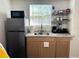 New kitchenette with stainless steel refrigerator and modern appliances at 1515 E Hanna Ave, Tampa, FL 33610