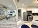 Open-concept living area features a modern kitchen, comfortable seating, and stylish decor at 1515 E Hanna Ave, Tampa, FL 33610