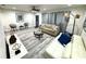 Bright and airy living room with hardwood floors, stylish furniture, and ample natural light at 1515 E Hanna Ave, Tampa, FL 33610