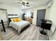 Cozy studio featuring hardwood floors, kitchenette, and comfortable bed at 1515 E Hanna Ave, Tampa, FL 33610