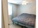 Comfortable bedroom with a ceiling fan, a bed with gray comforter and natural light at 15916 Marshfield Dr, Tampa, FL 33624