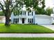 Charming two-story home with a well-manicured lawn and black shutters at 15916 Marshfield Dr, Tampa, FL 33624
