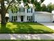 Charming two-story home with a well-manicured lawn and black shutters at 15916 Marshfield Dr, Tampa, FL 33624