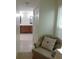 Hallway view leading to a bathroom with dual vanities and tiled floors at 15916 Marshfield Dr, Tampa, FL 33624