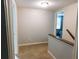 Upstairs hallway leading to bedrooms with neutral carpet and a light-filled ambiance at 15916 Marshfield Dr, Tampa, FL 33624