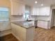 Bright kitchen features white cabinets, granite countertops, stainless steel appliances at 15916 Marshfield Dr, Tampa, FL 33624