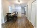 Bright kitchen and dining area with white cabinets, updated flooring, and stainless appliances at 15916 Marshfield Dr, Tampa, FL 33624