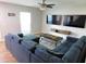 Cozy living room features modern furniture, two TVs, and updated flooring at 15916 Marshfield Dr, Tampa, FL 33624