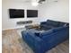 Cozy living room features modern furniture, two TVs, and updated flooring at 15916 Marshfield Dr, Tampa, FL 33624