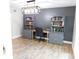 Stylish office area with built-in bookshelves, drawers, and a modern light fixture at 15916 Marshfield Dr, Tampa, FL 33624