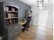 Office with custom cabinets, drawers, and a desk illuminated by a modern light at 15916 Marshfield Dr, Tampa, FL 33624