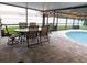 Enclosed patio with dining set and adjacent pool, perfect for entertaining at 15916 Marshfield Dr, Tampa, FL 33624
