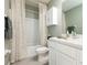 Stylish bathroom with white cabinetry, a tub-shower combo with patterned curtains and modern fixtures at 16624 Maude Dr, Wimauma, FL 33598