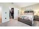 Bedroom featuring a cozy floral bed and a closet with ample storage and organization at 16624 Maude Dr, Wimauma, FL 33598