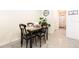 Cozy dining nook with a modern table set, decorative clock and accent lighting at 16624 Maude Dr, Wimauma, FL 33598