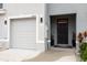 Welcoming entrance to this townhome featuring a one-car garage, and a covered porch at 16624 Maude Dr, Wimauma, FL 33598