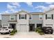 Charming townhome featuring a one car garage, neutral paint, and landscaped front yard at 16624 Maude Dr, Wimauma, FL 33598