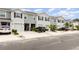 Well maintained townhomes featuring a one car garage, neutral paint, and landscaped front yards at 16624 Maude Dr, Wimauma, FL 33598