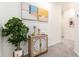 Inviting hallway featuring carpet floors and decorative wall art at 16624 Maude Dr, Wimauma, FL 33598