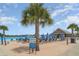 Enjoy the community beach with comfortable seating, shady umbrellas, and a tropical lagoon backdrop at 16624 Maude Dr, Wimauma, FL 33598