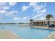 Cool off at the lagoon with ample seating, umbrellas, and a clear view of the community beach and amenities at 16624 Maude Dr, Wimauma, FL 33598