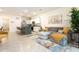 Open floor plan living room and kitchen with stainless steel appliances and stylish island seating at 16624 Maude Dr, Wimauma, FL 33598