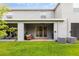 Enjoy the covered patio overlooking the yard, perfect for outdoor entertaining and relaxation at 16624 Maude Dr, Wimauma, FL 33598