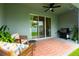 Cozy covered patio with grill and outdoor seating, perfect for relaxation and entertaining at 16624 Maude Dr, Wimauma, FL 33598