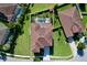 Drone's eye view of a home featuring a well-maintained roof, lush lawn, and tidy landscaping in a quiet neighborhood at 1947 Marshberry Ct, Trinity, FL 34655