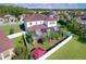 Overhead shot of a home boasting a screened-in pool, beautiful backyard landscaping, and serene neighborhood surroundings at 1947 Marshberry Ct, Trinity, FL 34655
