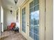 Tiled balcony with chair and side table, perfect for enjoying the outdoor space at 1947 Marshberry Ct, Trinity, FL 34655