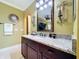 Stylish primary bathroom vanity with granite countertop, modern fixtures, and elegant sconces, creating a spa-like atmosphere at 1947 Marshberry Ct, Trinity, FL 34655