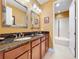 Bathroom with double sinks, granite countertops, and a separate tub at 1947 Marshberry Ct, Trinity, FL 34655