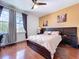 Bedroom with wood floor, stylish decor, and a relaxing color scheme at 1947 Marshberry Ct, Trinity, FL 34655