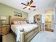 Bedroom with green accent wall, ceiling fan, and well-lit space at 1947 Marshberry Ct, Trinity, FL 34655