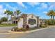 Sago Village entrance sign framed by palm trees and colorful foliage at 1947 Marshberry Ct, Trinity, FL 34655