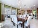 Dining area with elegant lighting open to kitchen and outdoor patio provides ideal entertainment flow at 1947 Marshberry Ct, Trinity, FL 34655