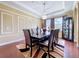 Dining area with decorative chandelier, large table, and hardwood floors at 1947 Marshberry Ct, Trinity, FL 34655