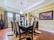Formal dining room with hardwood floors, a chandelier, and ample natural light at 1947 Marshberry Ct, Trinity, FL 34655