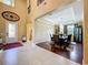 Open-concept dining area, hardwood flooring, with staircase and entryway view at 1947 Marshberry Ct, Trinity, FL 34655